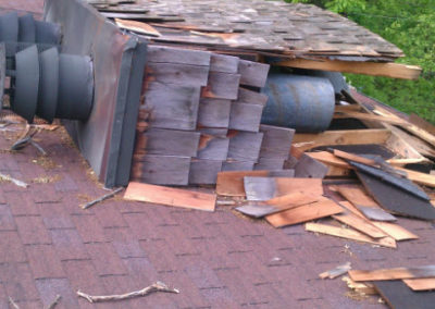 Destroyed Chimney Resting on Roof