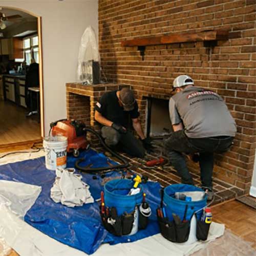 Technicians Cleaning Fireplace
